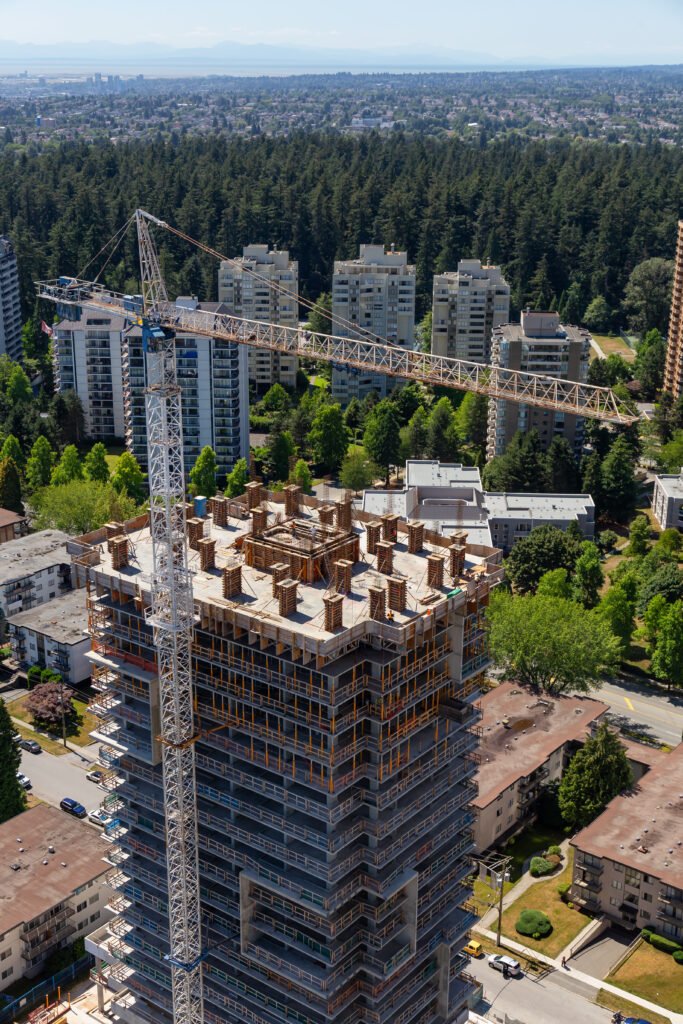 aerial view of a residential building construction site during a sunny summer day